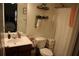 Well-lit bathroom with modern fixtures, patterned shower curtain, and ample storage at 5230 Centennial Hill Nw Dr, Acworth, GA 30102