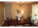 Formal dining room with a chandelier and a wooden table set for a dinner gathering at 5230 Centennial Hill Nw Dr, Acworth, GA 30102