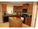 Well-lit kitchen featuring an island, tile floor, granite countertops, and stainless steel appliances at 5230 Centennial Hill Nw Dr, Acworth, GA 30102