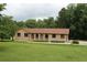 Charming single-story brick home with arched entries and a well-manicured lawn at 5513 N Richland Creek Rd, Buford, GA 30518