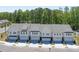 Aerial view of new construction townhomes with grey shingles and well maintained landscaping at 2409 Malster Ln, Lawrenceville, GA 30043
