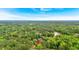 Aerial view of property nestled among lush trees with lake in the distance at 597 Rich Davis Rd, Hiram, GA 30141