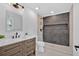 Modern bathroom featuring a gray tiled shower, sleek vanity, and stylish mirror at 597 Rich Davis Rd, Hiram, GA 30141
