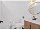 Bright bathroom featuring a stylish vanity, modern mirror, and toilet at 597 Rich Davis Rd, Hiram, GA 30141