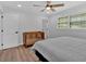 Bright bedroom featuring a window, ceiling fan, crib, and bed at 597 Rich Davis Rd, Hiram, GA 30141