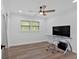 Bright bedroom features a ceiling fan, window, desk, and chair at 597 Rich Davis Rd, Hiram, GA 30141