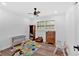 Bright playroom bedroom featuring a ceiling fan, window, play mat, and toddler toys at 597 Rich Davis Rd, Hiram, GA 30141