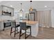 Stylish kitchen features a butcher block island, gray cabinets, stainless steel appliances, and modern pendant lights at 597 Rich Davis Rd, Hiram, GA 30141