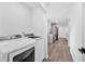 Bright laundry room leads to the kitchen; features a modern white washer and dryer at 597 Rich Davis Rd, Hiram, GA 30141