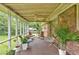 Charming screened porch with plants and room for seating, great for relaxation and enjoying the backyard view at 597 Rich Davis Rd, Hiram, GA 30141