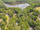 Areal view of the tree covered property with a lake nearby at 6360 Lakeview Ter, Douglasville, GA 30135
