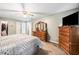 Spacious bedroom with a ceiling fan, carpet, and wooden dressers at 6360 Lakeview Ter, Douglasville, GA 30135