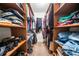Walk-in closet with wood shelving and plenty of storage space at 6360 Lakeview Ter, Douglasville, GA 30135
