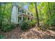 Beautiful two-story home with a front porch nestled among lush trees and landscaping at 6360 Lakeview Ter, Douglasville, GA 30135