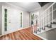 Inviting foyer with wood-look floors, white doors, staircase, and views into the living spaces at 6360 Lakeview Ter, Douglasville, GA 30135