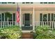 Inviting front porch view features a swing, American flag, and lush landscaping at 6360 Lakeview Ter, Douglasville, GA 30135