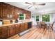 Traditional kitchen with wood cabinets, wood-look flooring, stainless sink, and an adjacent breakfast nook at 6360 Lakeview Ter, Douglasville, GA 30135