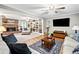 Spacious living room with a brick fireplace, built-in bookshelves, and hardwood floors at 6360 Lakeview Ter, Douglasville, GA 30135