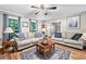 Comfortable living room with a ceiling fan, plush sofas, and natural light at 6360 Lakeview Ter, Douglasville, GA 30135