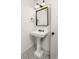 Bright bathroom with a pedestal sink, classic fixtures, and decorative mirror at 1002 Forrest Blvd, Decatur, GA 30030