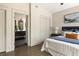 Bedroom view into bathroom with hardwood floors, a king bed, and neutral tones at 1002 Forrest Blvd, Decatur, GA 30030