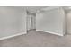 Neutral hallway showing multiple doors, carpeting, and natural light at 2413 Malster Ln, Lawrenceville, GA 30043
