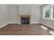 Bright living room featuring a fireplace with a light wood mantle and hardwood flooring at 2413 Malster Ln, Lawrenceville, GA 30043
