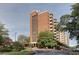 Brick high rise with balconies featuring mature trees and greenery at 300 Johnson Ferry Rd # A614, Atlanta, GA 30328