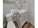Cozy bathroom featuring a vanity with storage, a toilet, and neutral-colored walls at 7054 Chappell Cir, Atlanta, GA 30360