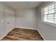 This bedroom offers wood-look flooring and a window at 7054 Chappell Cir, Atlanta, GA 30360