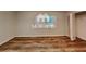 This is an empty bedroom with a wooden floor, a window and a closet at 7054 Chappell Cir, Atlanta, GA 30360