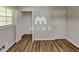 This is an empty bedroom featuring a wooden floor, a window, a closet and a door at 7054 Chappell Cir, Atlanta, GA 30360