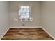 This is an empty bedroom featuring a wooden floor and a window at 7054 Chappell Cir, Atlanta, GA 30360