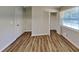 Bright bedroom features wood-look flooring, a window, and a closet at 7054 Chappell Cir, Atlanta, GA 30360