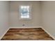 This bedroom features wood-look flooring and a window at 7054 Chappell Cir, Atlanta, GA 30360