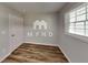 This is an empty bedroom featuring a window and a wooden floor at 7054 Chappell Cir, Atlanta, GA 30360
