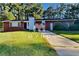 Charming single-story brick home with a well-maintained lawn and a concrete driveway at 7054 Chappell Cir, Atlanta, GA 30360