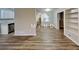 Open living space with an adjacent kitchen, wood-look flooring, and neutral paint at 7054 Chappell Cir, Atlanta, GA 30360
