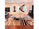 Open dining area with white chairs, modern table, and stylish black and white wall decorations at 1463 Macklone Ne St, Atlanta, GA 30307