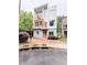 Modern three-story home featuring a unique architectural design with a bright orange door and matching balcony accents at 1463 Macklone Ne St, Atlanta, GA 30307