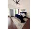 Spacious main bedroom with a luxurious blue bed, elegant decor, and ample natural light at 1463 Macklone Ne St, Atlanta, GA 30307