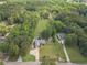 Aerial view showcasing a beautiful home with a long driveway surrounded by abundant trees and lush greenery at 1623 Pratt Rd, Covington, GA 30014