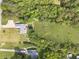 Aerial shot showcases the home's yard with pool, garden and trampoline, bordered by trees at 1623 Pratt Rd, Covington, GA 30014