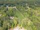 Expansive aerial view showing the property's lush surroundings, bordering a forest and other homes in a neighborhood at 1623 Pratt Rd, Covington, GA 30014