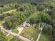 Aerial view of a charming home with a long driveway surrounded by lush greenery, enhancing its curb appeal at 1623 Pratt Rd, Covington, GA 30014