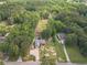 An aerial view showcases two homes with long driveways surrounded by lush greenery and mature trees at 1623 Pratt Rd, Covington, GA 30014