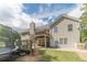 View of the home's backyard with a wood deck, lush lawn, and outdoor recreational equipment at 1623 Pratt Rd, Covington, GA 30014