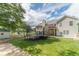 Expansive backyard view featuring a trampoline, shed, and lush green lawn at 1623 Pratt Rd, Covington, GA 30014