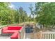 Backyard view from the deck features lush trees, trampoline, and a shed for storage at 1623 Pratt Rd, Covington, GA 30014