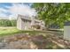 Spacious backyard featuring a deck, trampoline, and mature trees, offering privacy and room to play at 1623 Pratt Rd, Covington, GA 30014